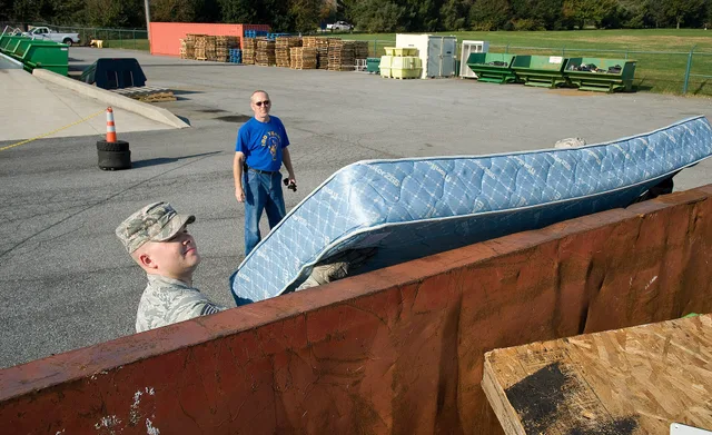 Deral Freysinger, 436th Civil Engineer Squadron qualified recycling program manager, watches Staff Sgt. Jonathan Judy, 436th CES airmen dormitory leader, place a mattress in a 30-cubic yard roll-off container Nov. 3, 2016, at the Recycling Center on Dover Air Force Base, Del. Freysinger ensured all. 7 things to check in dumpster rental software